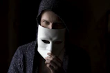 person in black knit cap and gray sweater