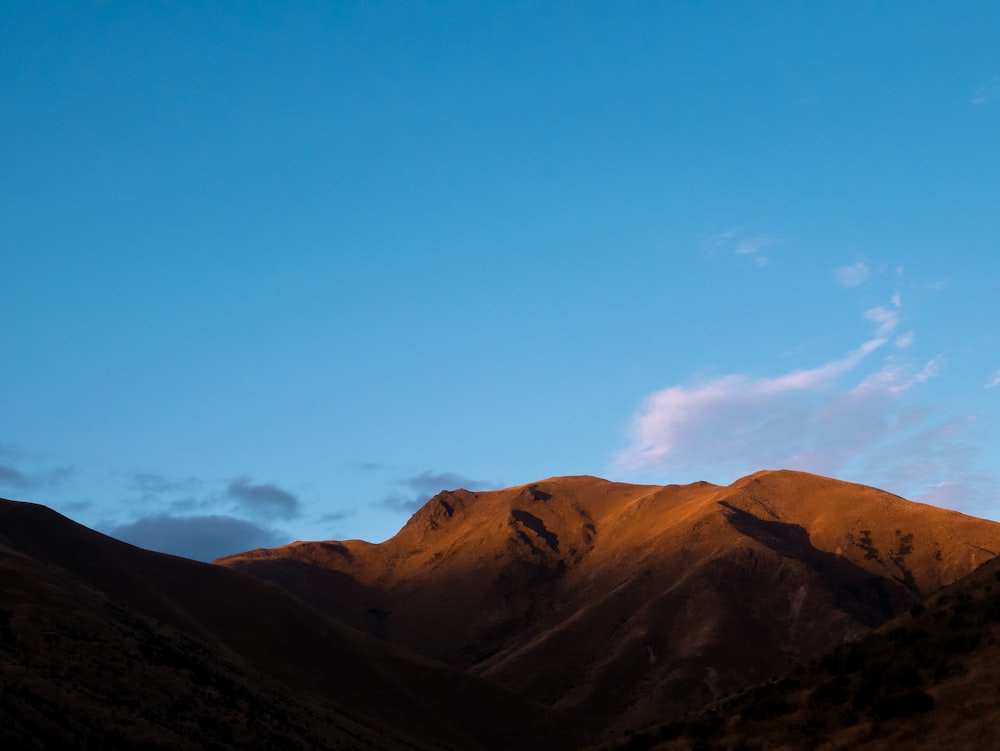 brown mountains under blue sky during daytime