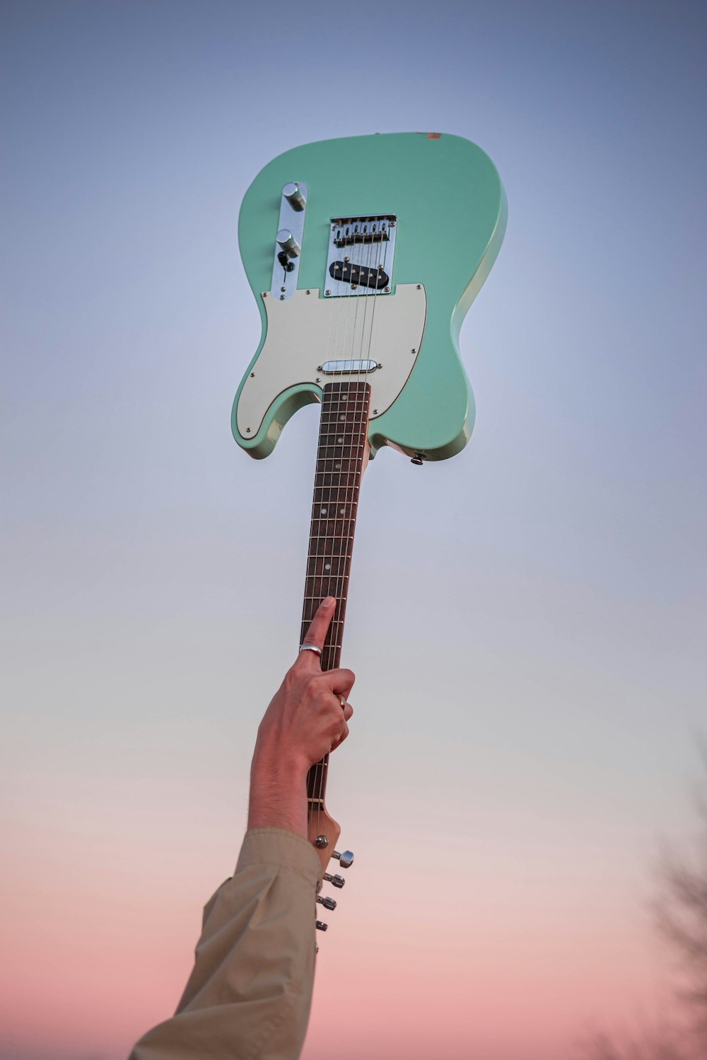 teal and white electric guitar