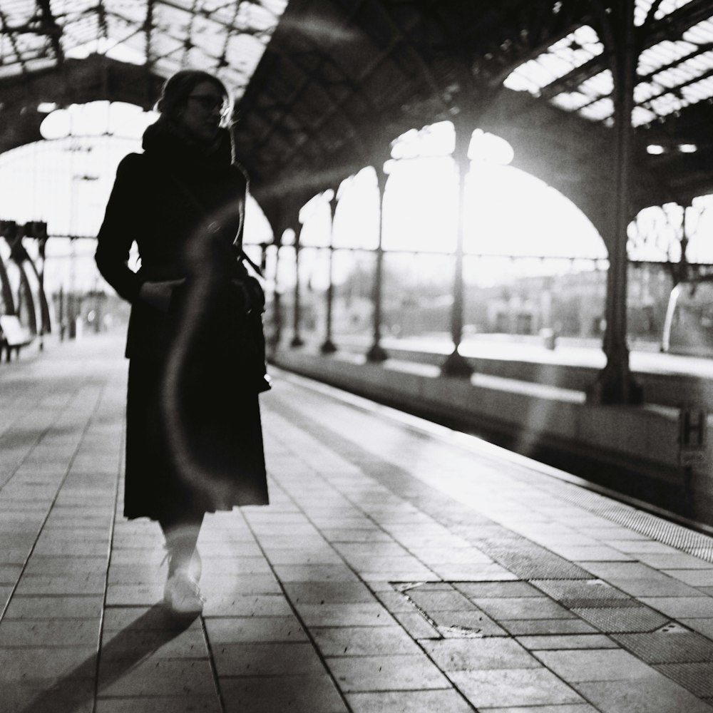 woman in black dress holding umbrella