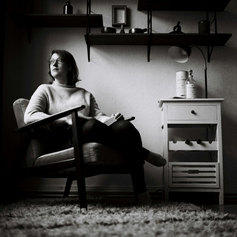 woman in white sweater sitting on chair