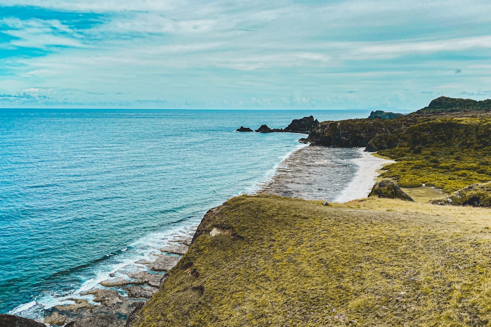 brown rocky shore under blue sky during daytime