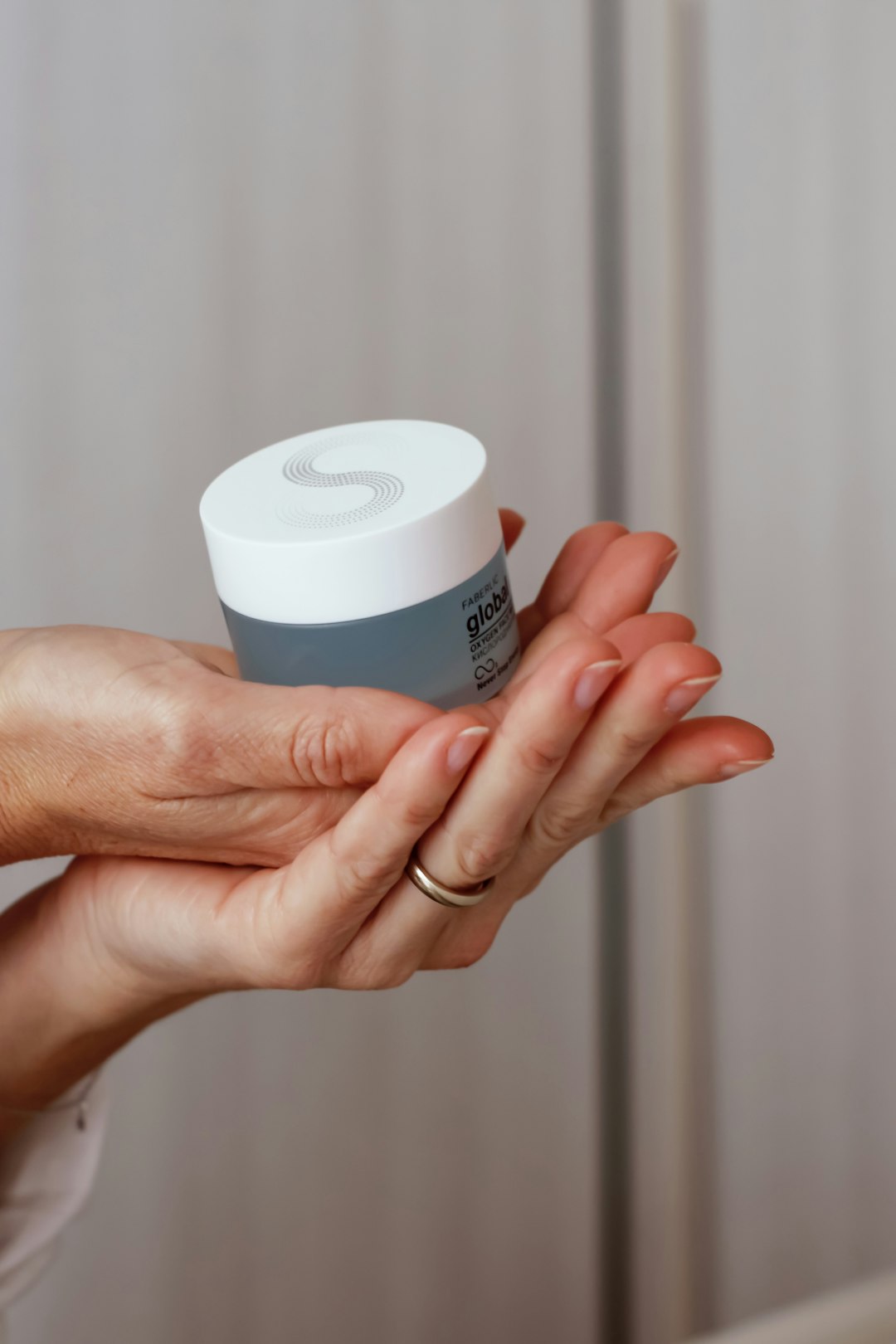 person holding white plastic cup