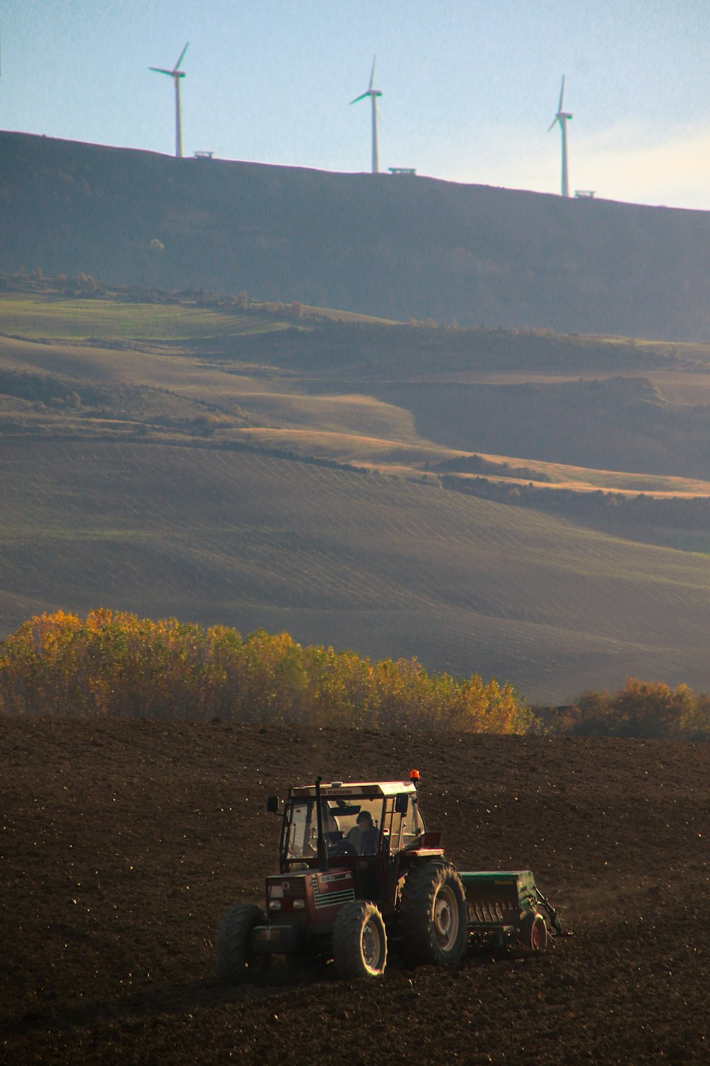 yellow and black tractor on green grass field during daytime