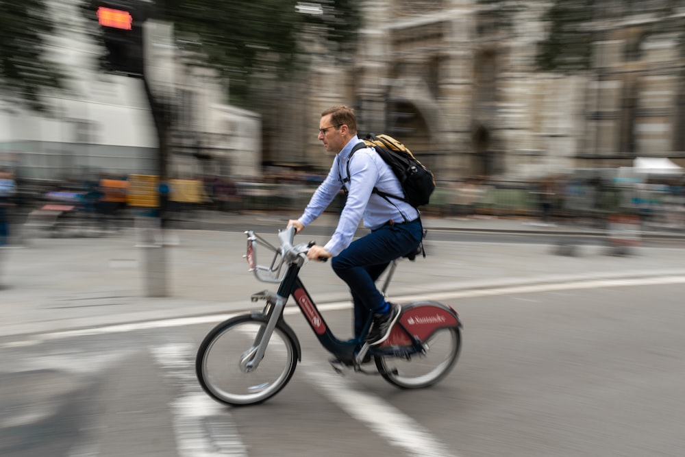 man in blue jacket riding red motorcycle during daytime