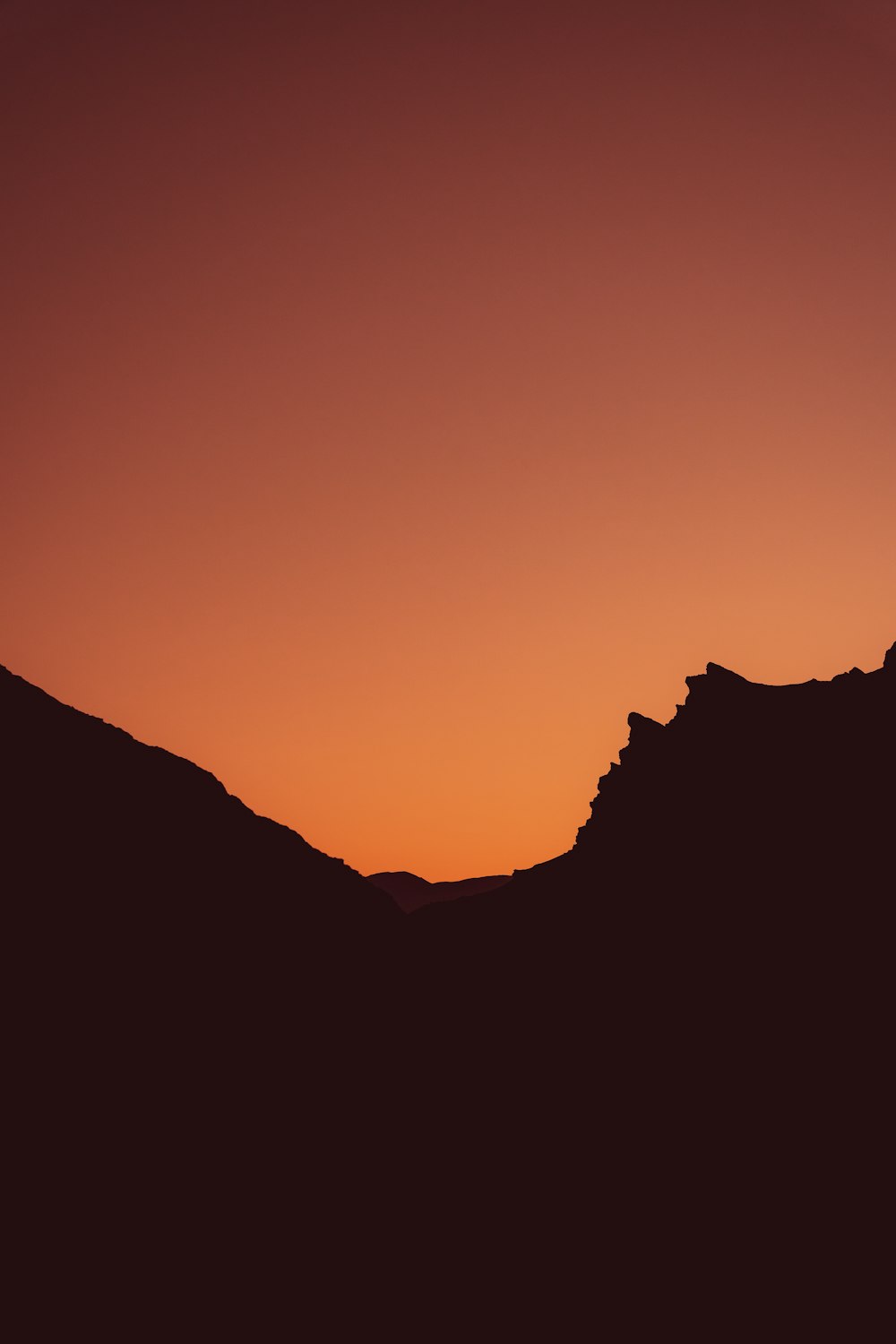 silhouette of mountain during sunset