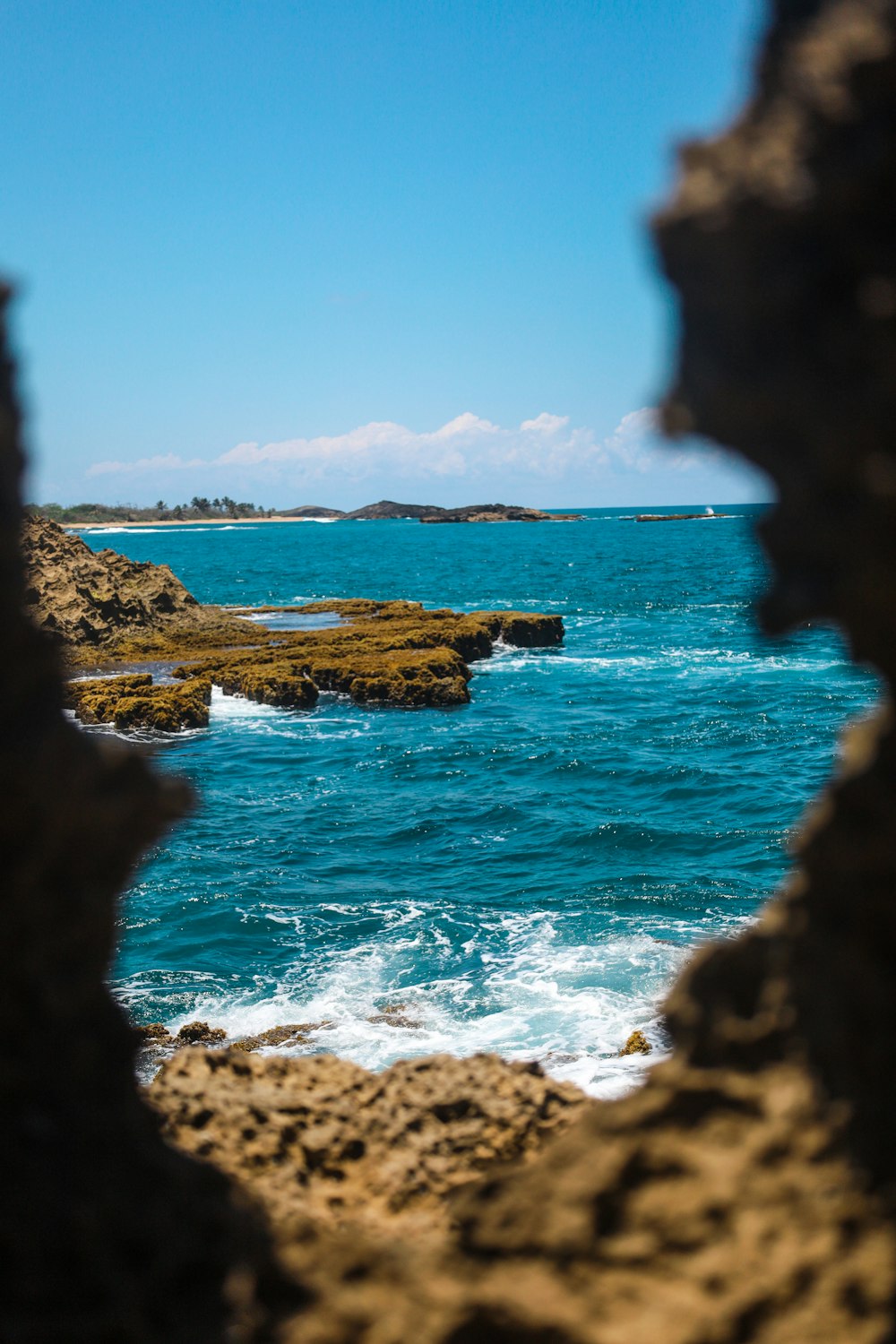 brown rock formation near body of water during daytime