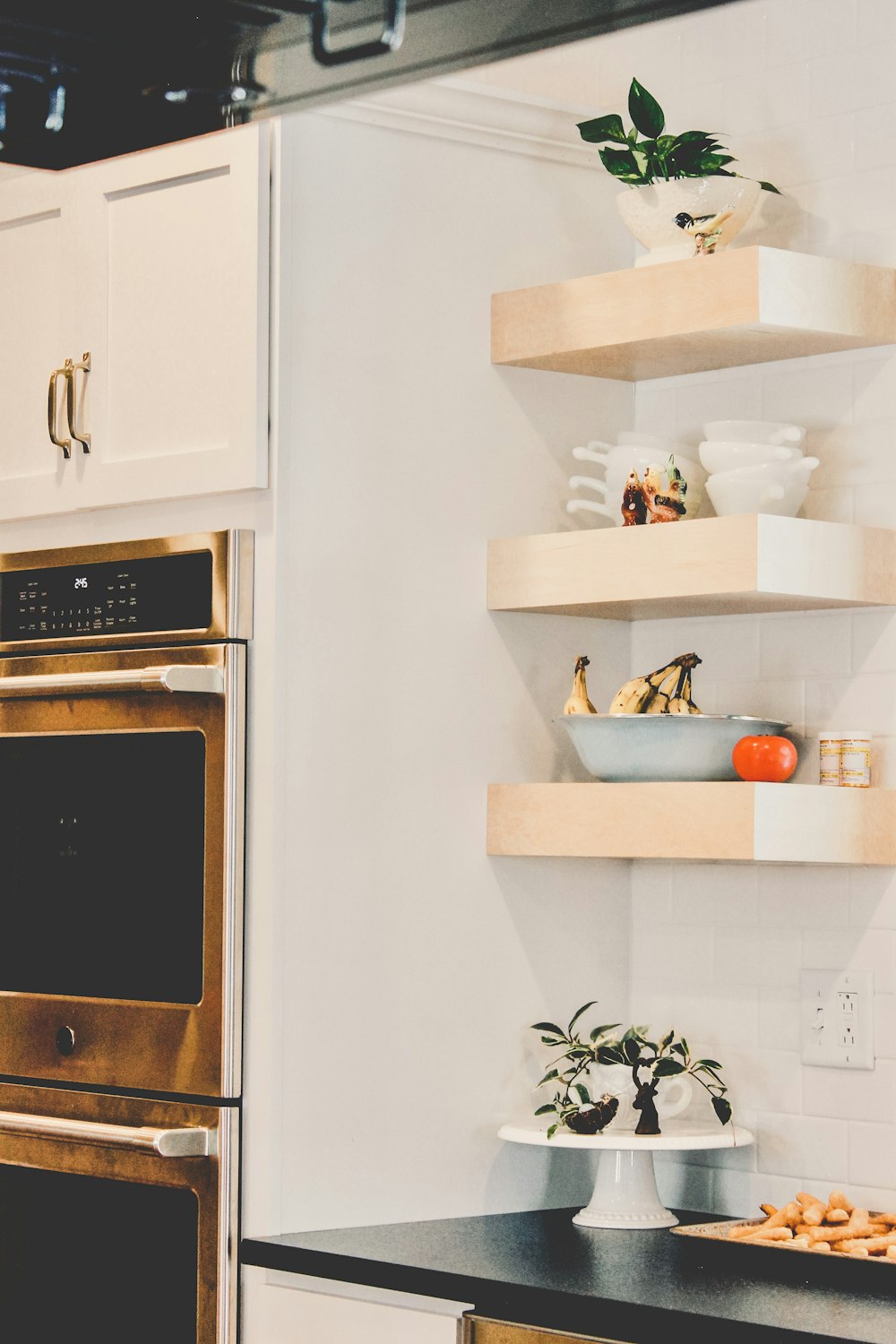 white wooden shelf with green plant