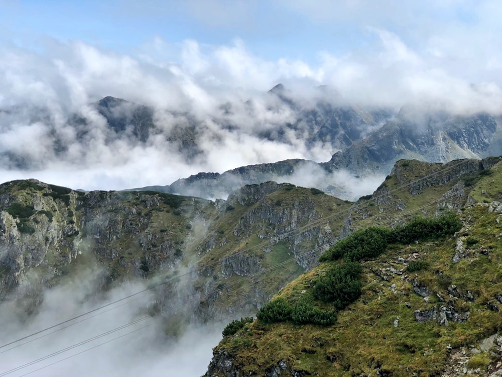 green and gray mountain under white clouds during daytime