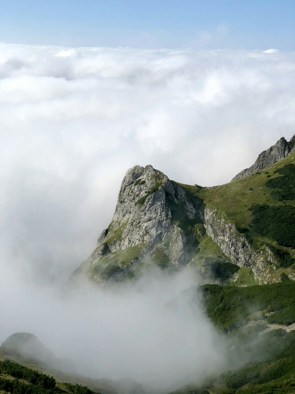 green and gray mountain under white clouds