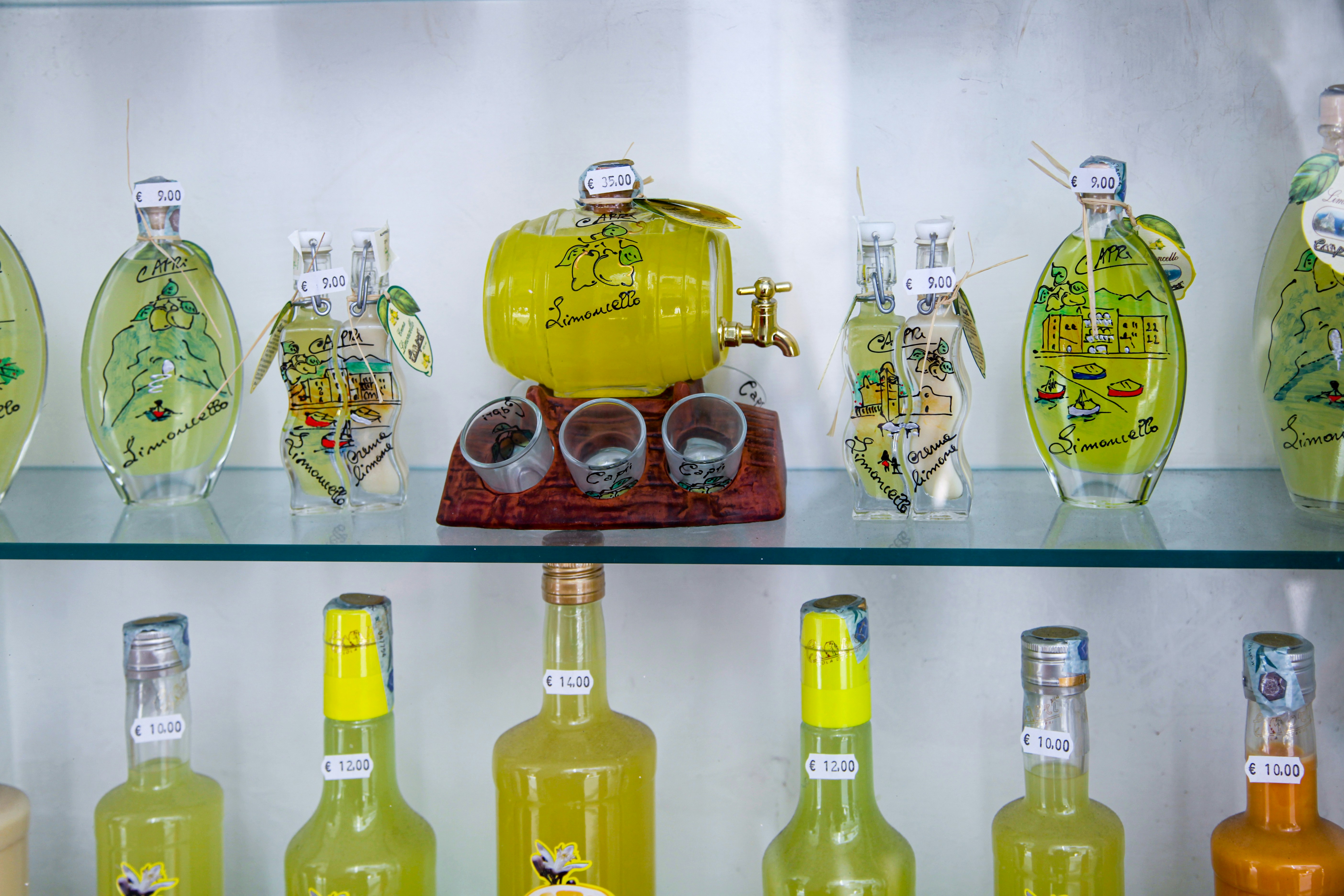 assorted bottles on glass shelf