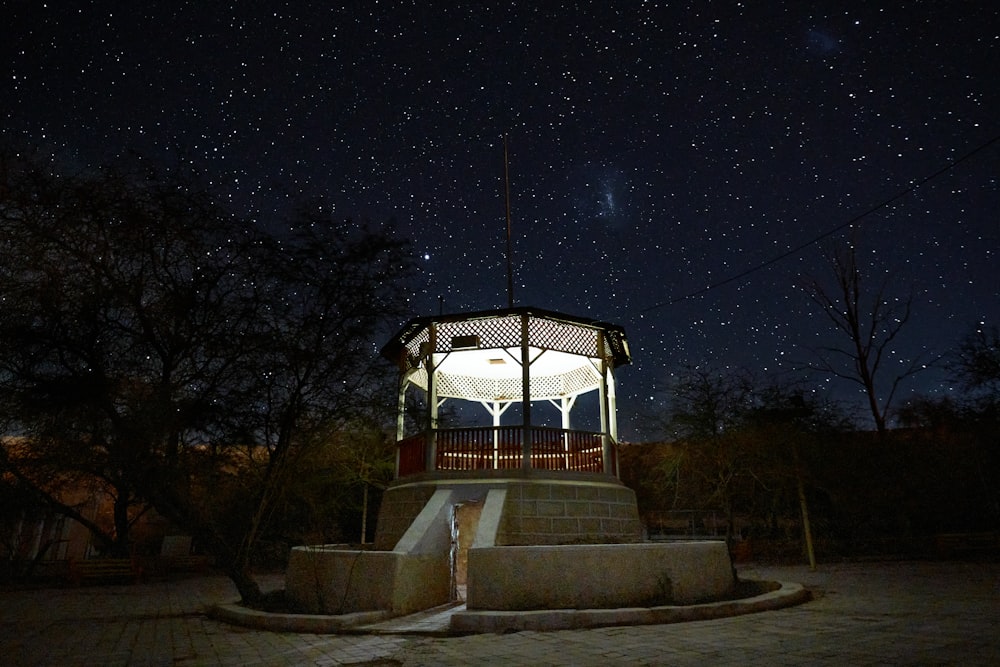 white and brown wooden gazebo during night time