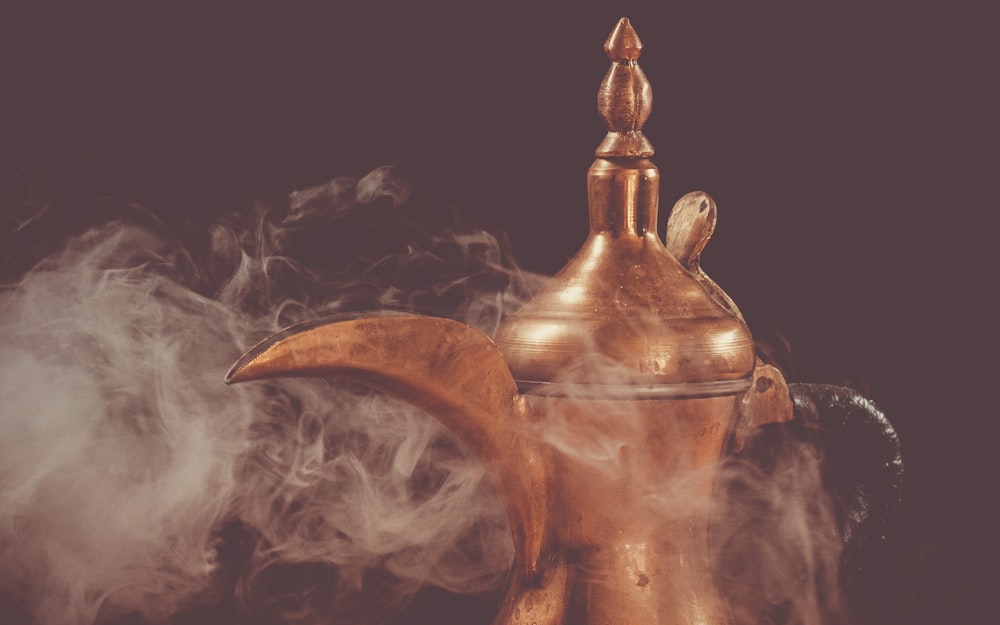 Brass teapot with smoke on black background photo – Free Grey