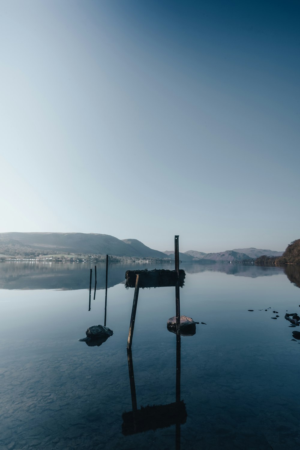 black metal stand near body of water during daytime