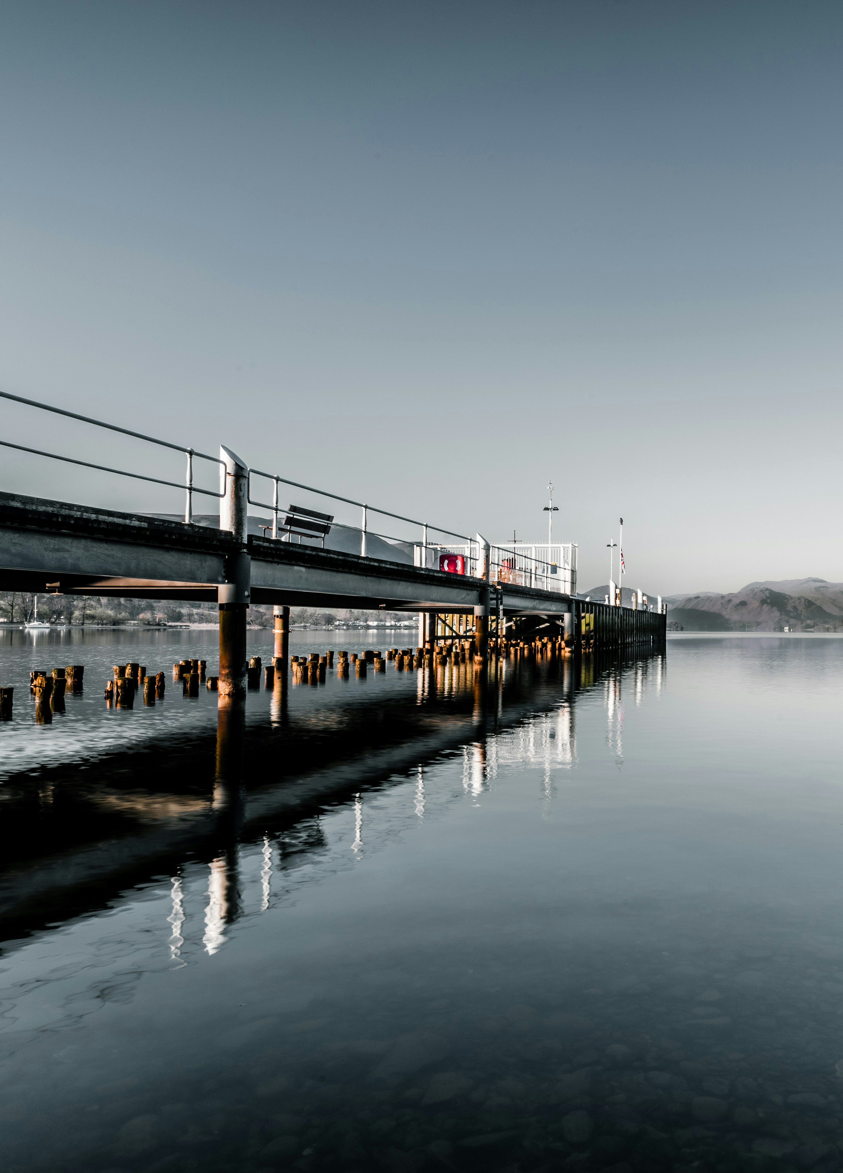 brown wooden dock on body of water during daytime