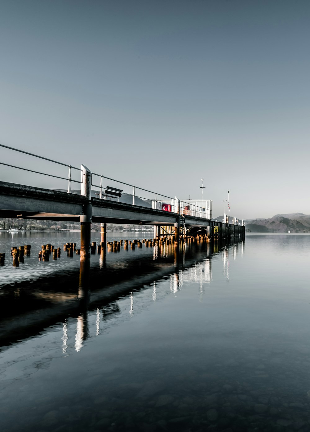 brown wooden dock on body of water during daytime