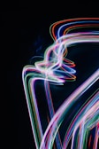 Abstract light trails and particle effects illustrating dynamic motion graphics in a dark studio.