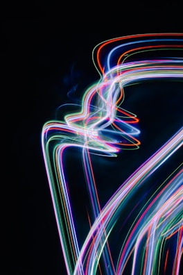 Abstract light trails and particle effects illustrating dynamic motion graphics in a dark studio.