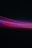 A photograph capturing vibrant streaks of light in various colors against a dark background. The lights form a wave-like pattern with predominant hues of red, purple, and blue.