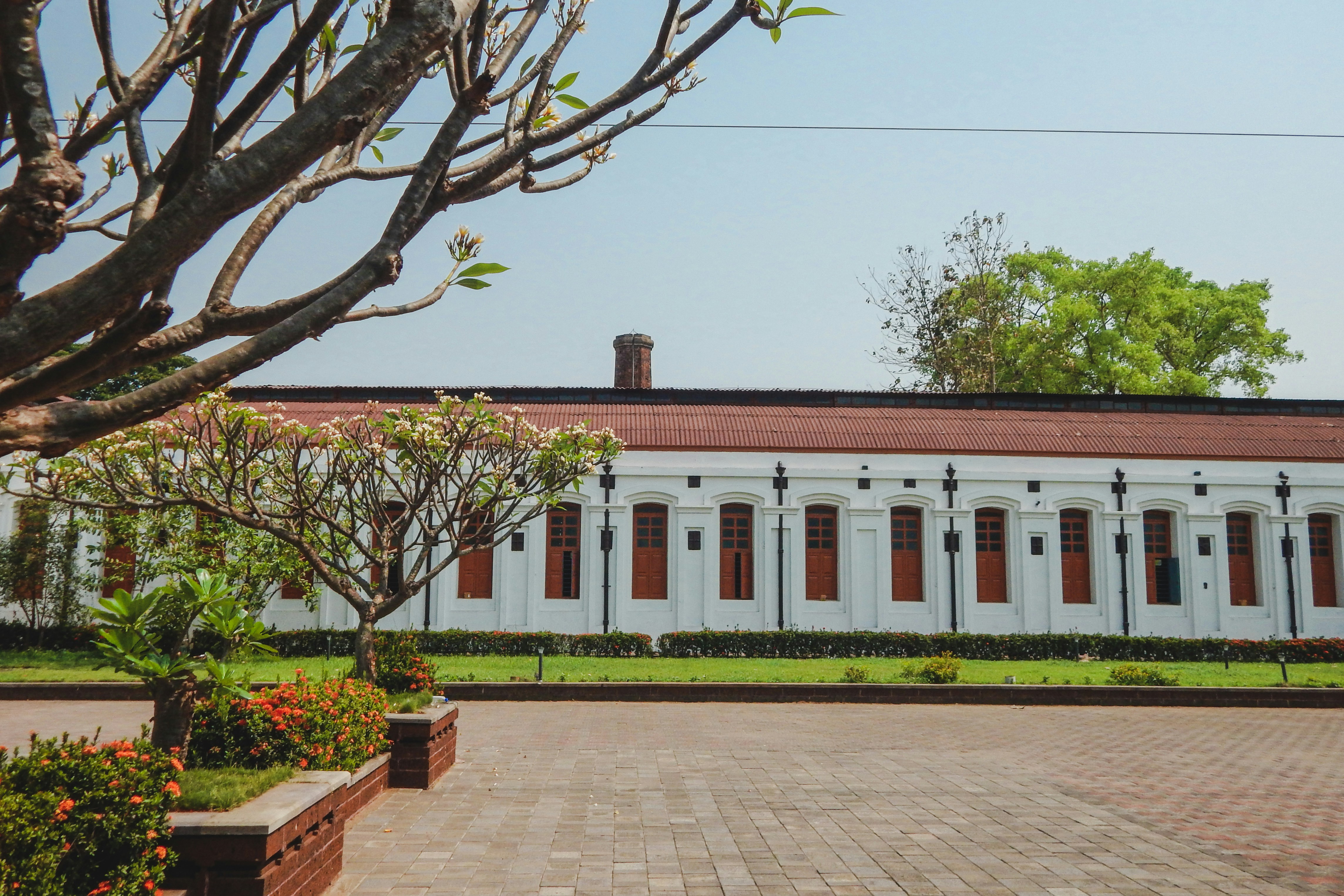 white concrete building near green trees during daytime