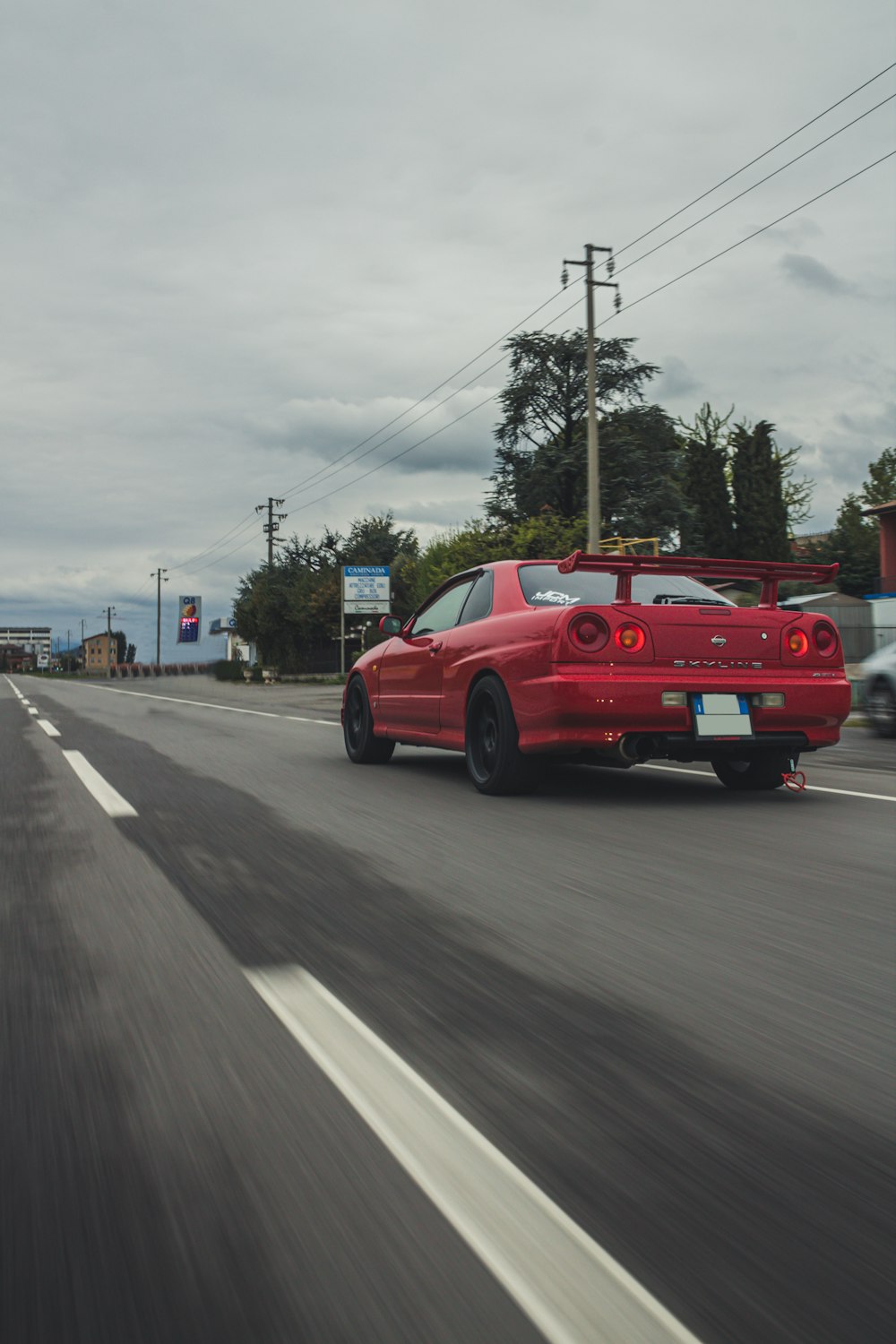 red car on road during daytime