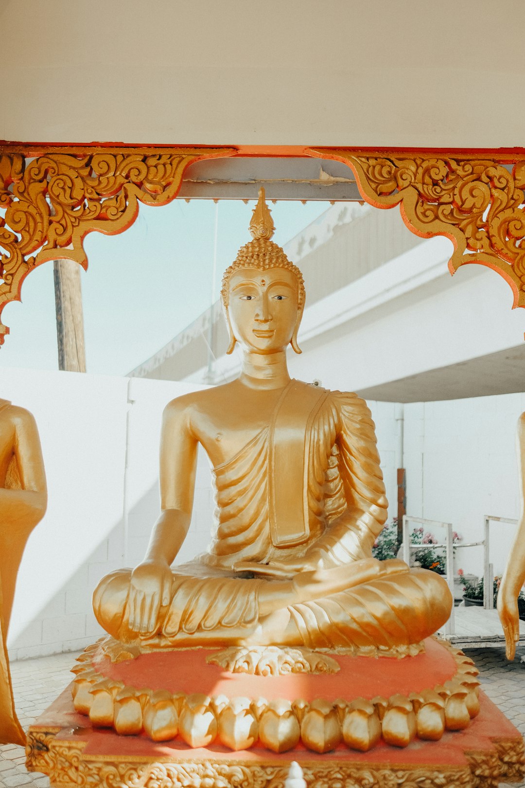 gold buddha statue near white wall