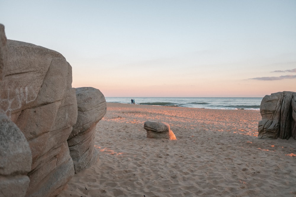 brown rock formation on beach during daytime