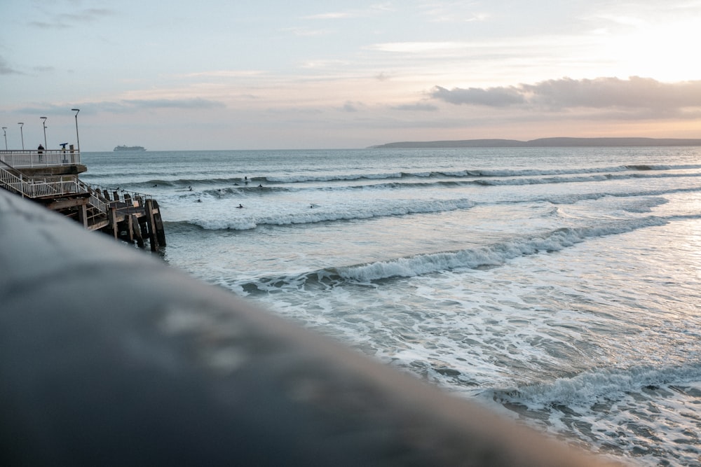 sea waves crashing on shore during sunset