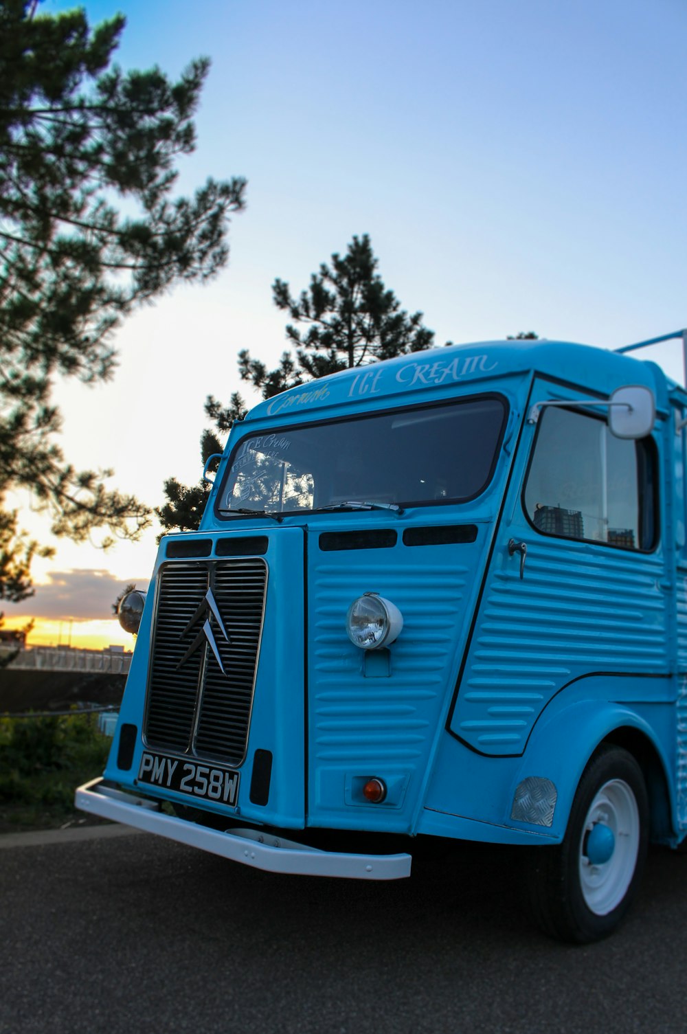 blue and white truck on road during daytime