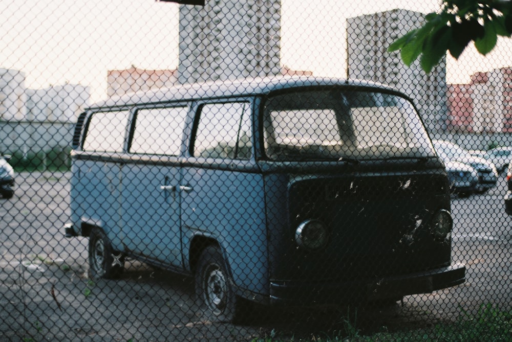 blue and white van parked on gray concrete road