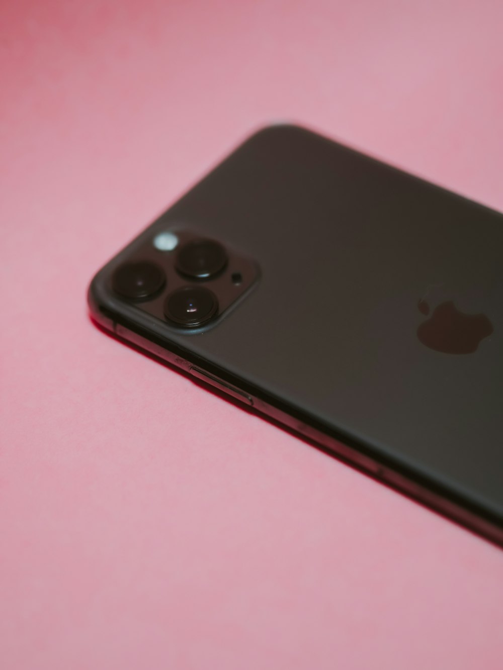 black iphone 7 on pink table