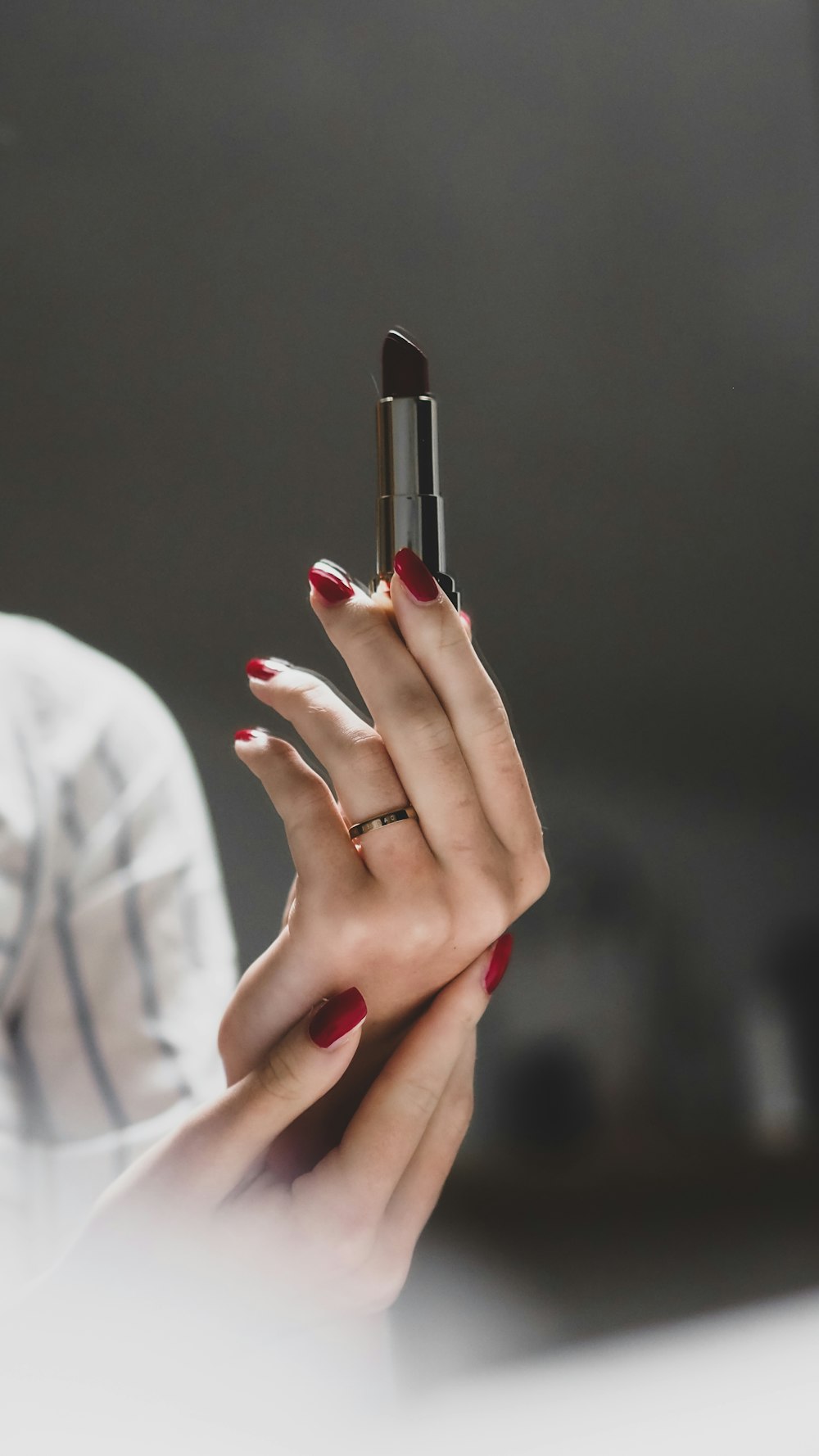 woman with red manicure and silver ring