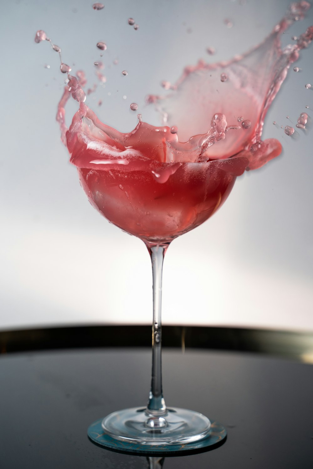 red liquid in clear wine glass