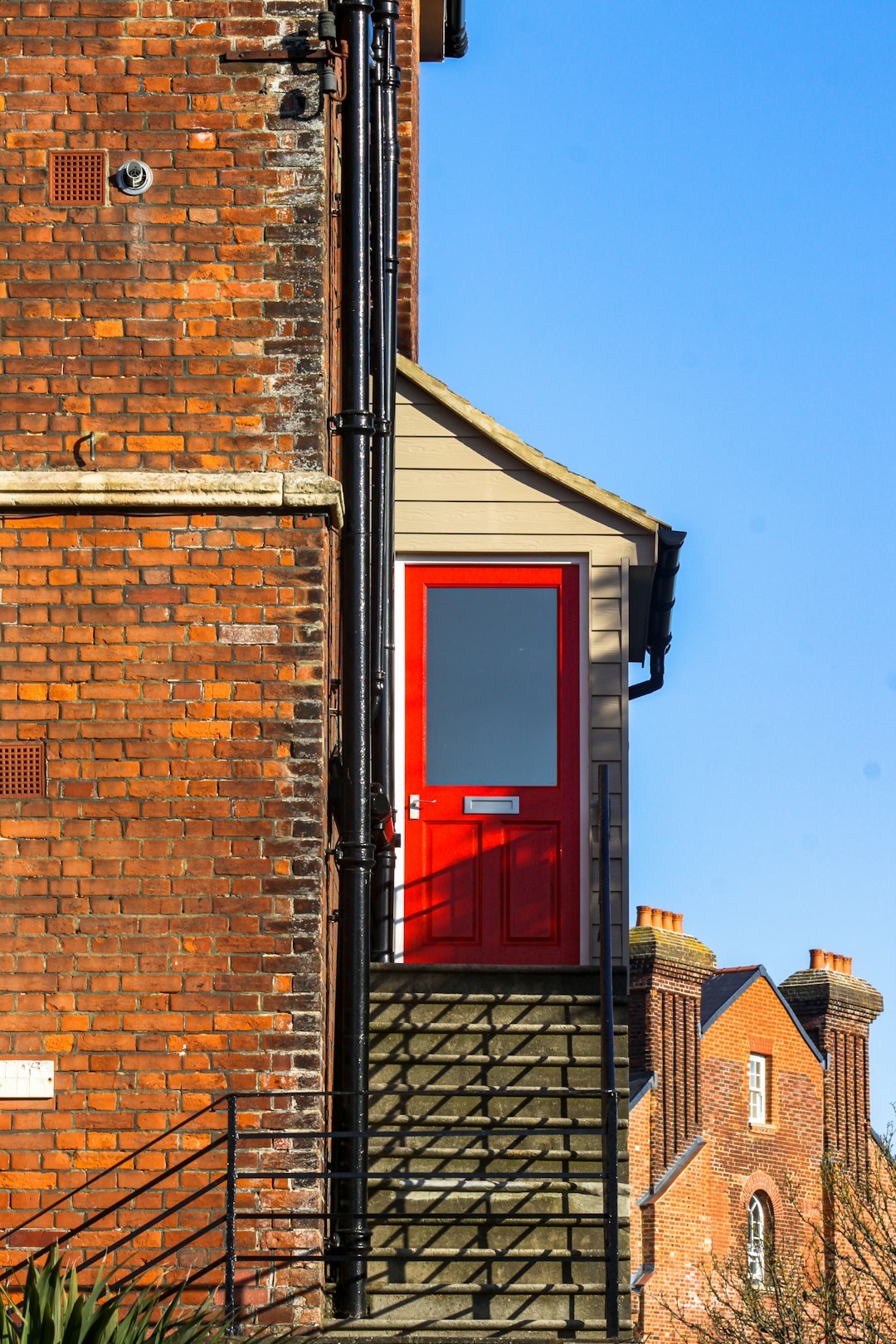 brown brick building with red wooden window