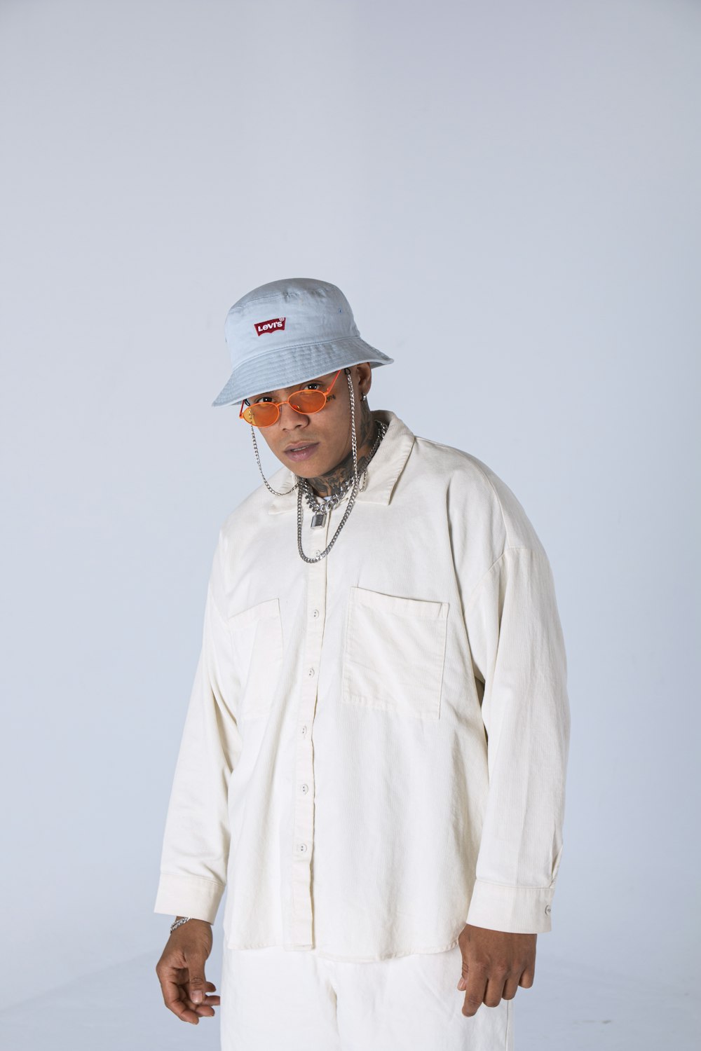 man in white zip up jacket and white cap