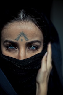 woman with black hair covering her face