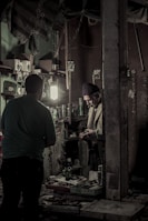 A locksmith carefully duplicating keys in a bright, organized workshop.
