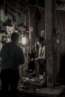 Artisan hands assembling bespoke packaging boxes in the workshop.