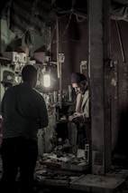 A young Vietnamese man packing orders carefully in a home workshop.