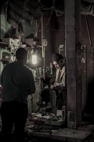 Smiling staff wearing custom caps while packing orders in a cozy workshop.