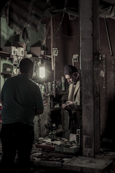 A young Vietnamese man packing orders carefully in a home workshop.