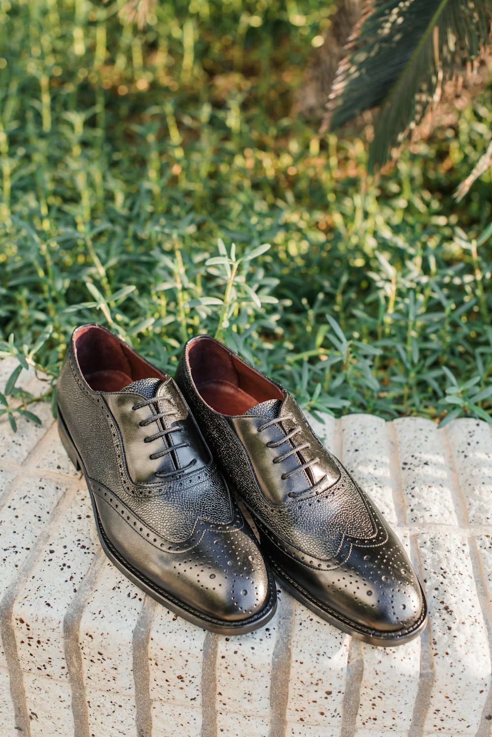 brown leather lace up shoes on brown concrete floor