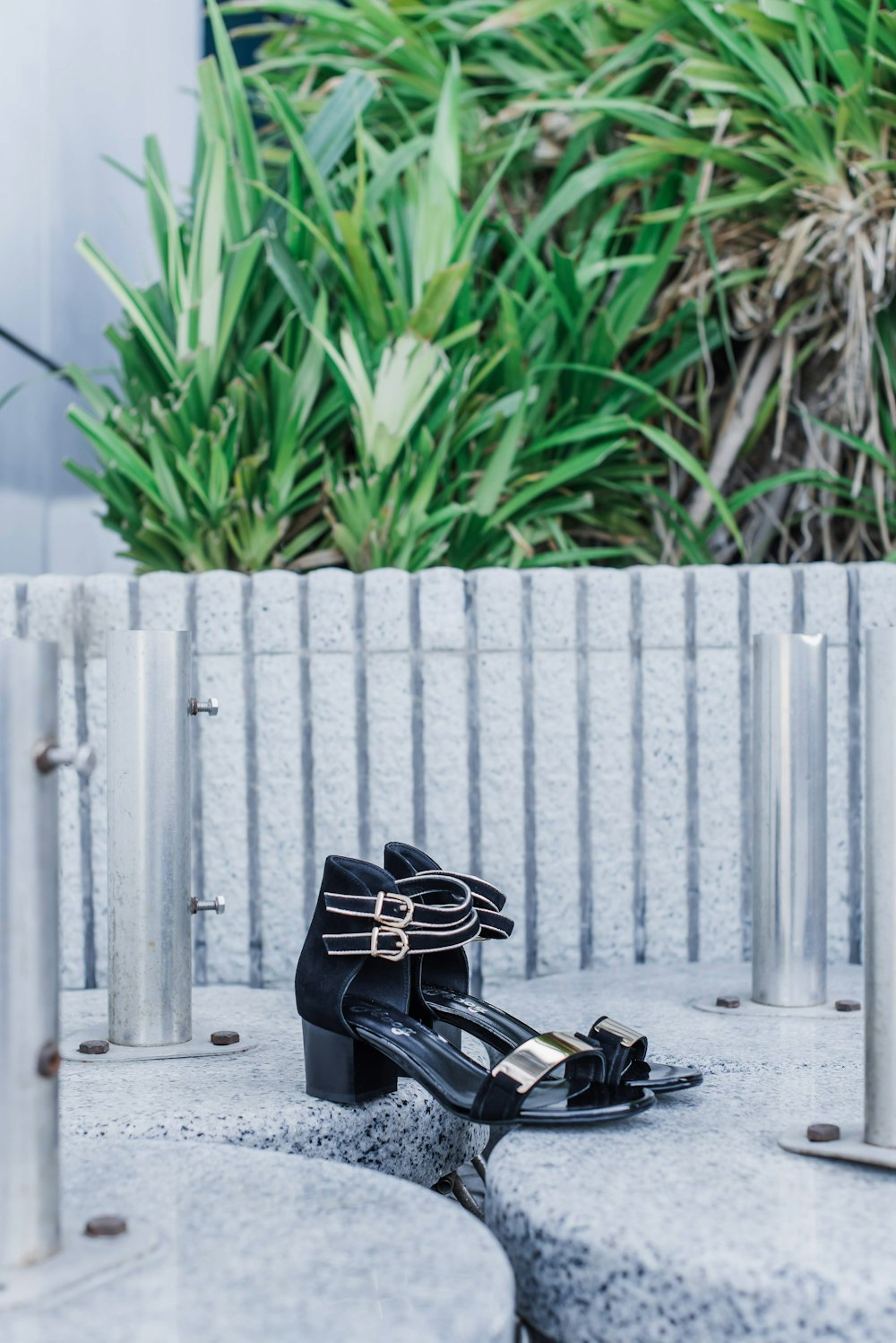 black leather bag on gray concrete bench