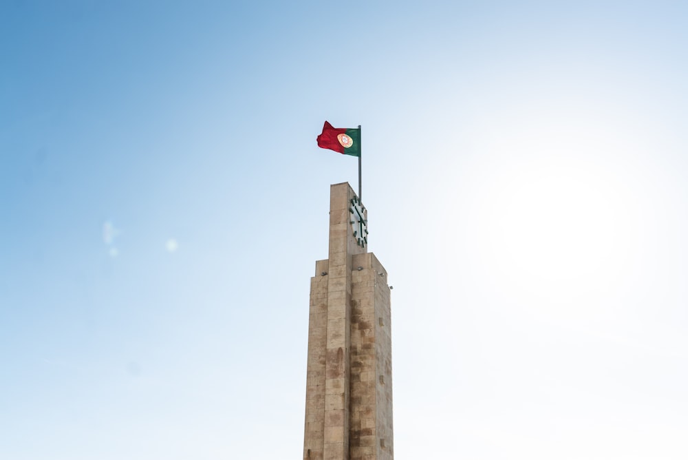 red and white flag on top of brown concrete building