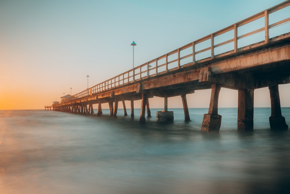 brown wooden dock on body of water during daytime