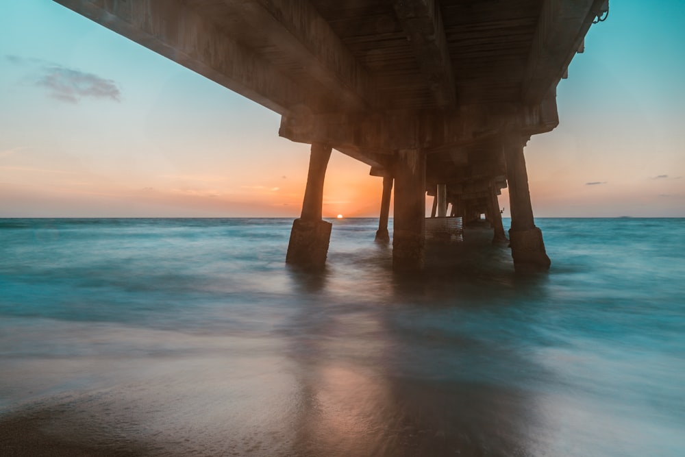 brown wooden dock on blue sea under blue sky during daytime