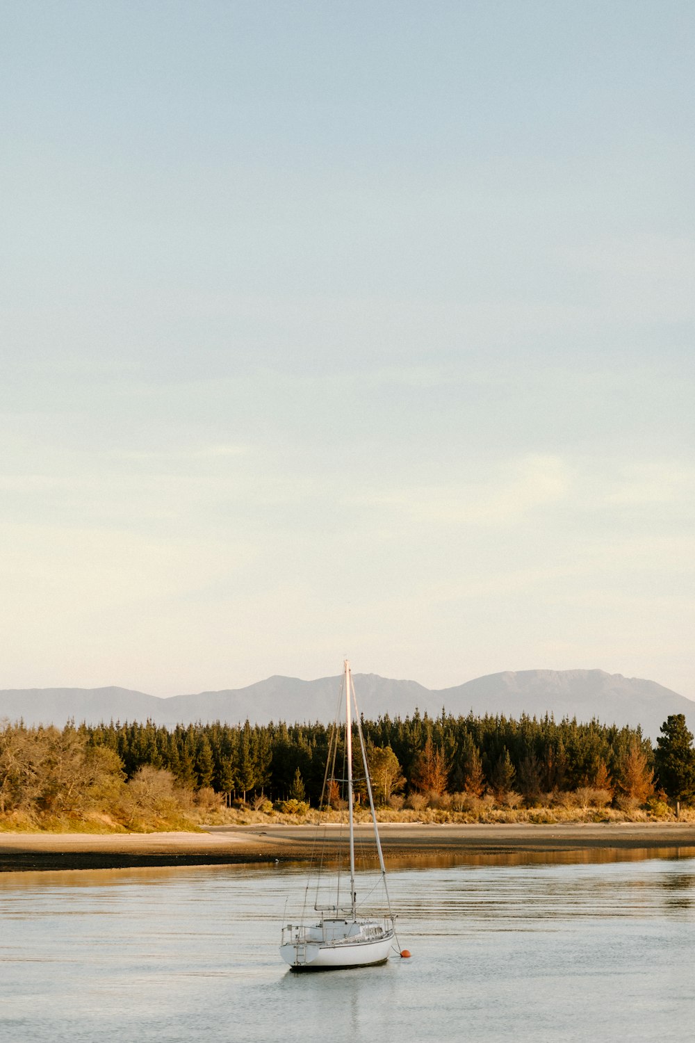 white sail boat on body of water during daytime