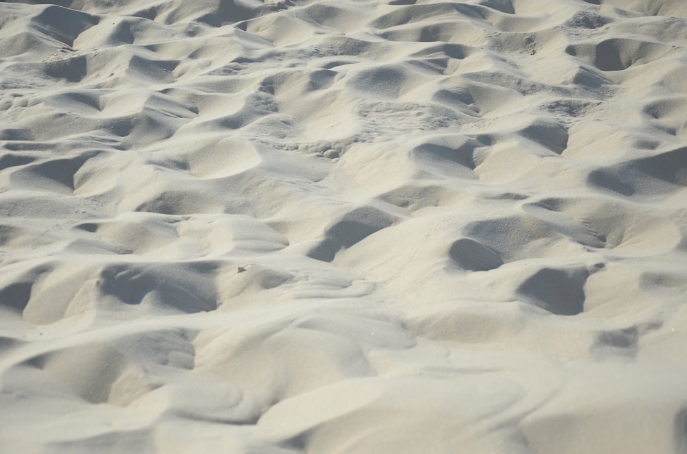 white sand with footprints during daytime