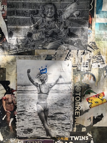 A collage of various posters with distinct images and artistic styles. The top image features a black-and-white photograph of a smiling child surrounded by pigeons. Below, a black-and-white photo shows a person in swimwear facing the ocean with arms raised and a small crown drawing on their head. Surrounding these are various patches of torn posters and stickers with vibrant colors and mixed textures.