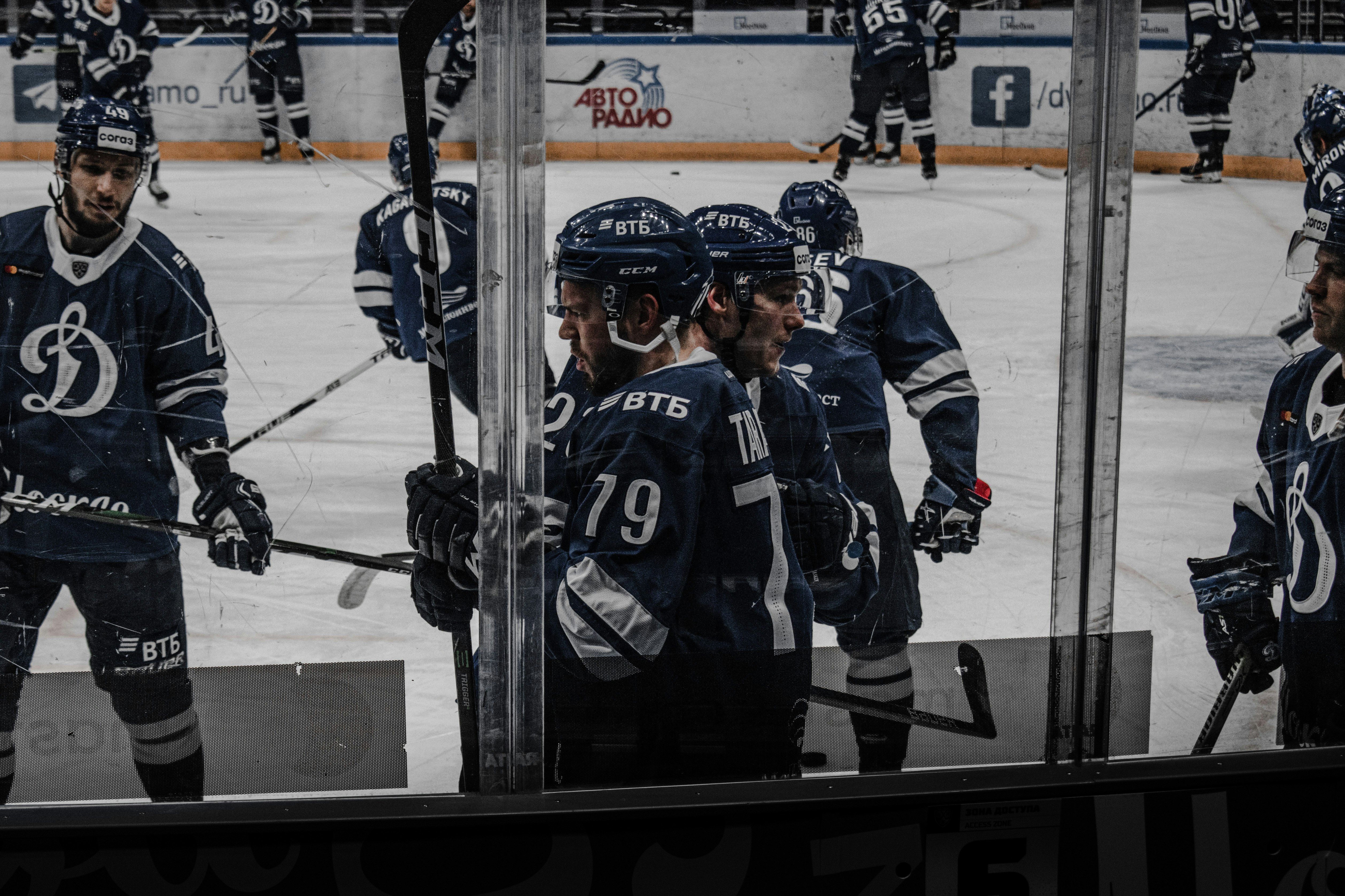 2 men in black ice hockey jersey standing on ice hockey field